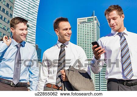 Group of colleagues walking while talking after work View Large Photo Image Stock Image - Group of colleagues walking while talking after work. Fotosearch