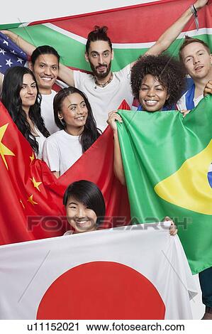 Group of multi-ethnic friends holding various national flags against white background View Large Photo Image Stock Image - Group of multi-ethnic friends holding various national flags against white background. Fotosearch