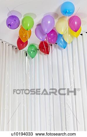 Stock Image - Group of multicolored helium party balloons. Fotosearch
