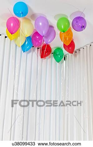 Stock Image - Group of multicolored helium party balloons. Fotosearch