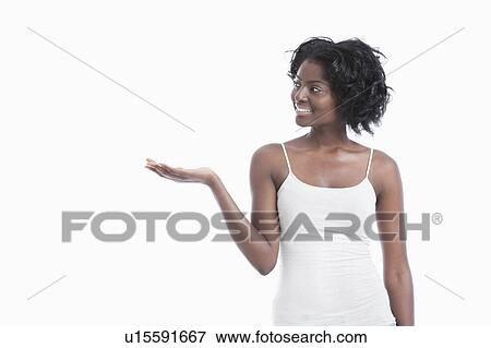 Stock Photo - Happy African American young woman holding his palm out over white background. Fotosearch