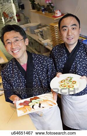 Happy Asian chefs with Japanese cuisines in restaurant View Large Photo Image Stock Photo - Happy Asian chefs with Japanese cuisines in restaurant. Fotosearch