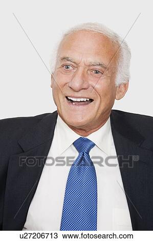 Stock Image - Happy elderly businessman against white background. Fotosearch