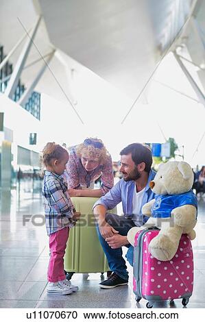 Happy family on a holiday arriving at the airport View Large Photo Image Stock Image - Happy family on a holiday arriving at the airport. Fotosearch