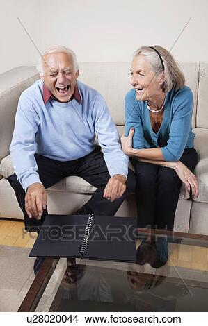 Picture - Happy senior woman looking at spouse laughing. Fotosearch