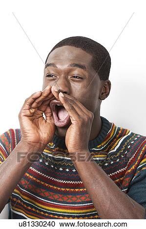 Stock Image - Happy young African American man shouting against white background. Fotosearch