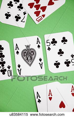 Stock Photography - High angle view of a playing cards on green surface. Fotosearch
