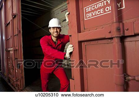Hispanic worker opening industrial railway carriage View Large Photo Image Stock Image - Hispanic worker opening industrial railway carriage. Fotosearch