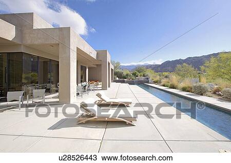Stock Image - House exterior with lap pool. Fotosearch