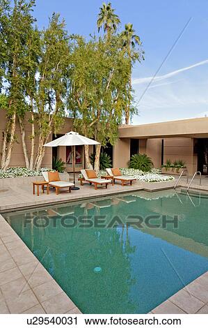 Stock Image - House exterior with pool. Fotosearch