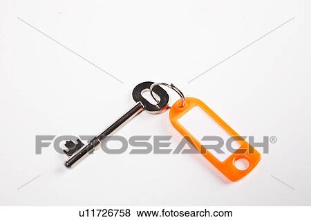 Stock Photo - Key with orange key ring tag on white background. Fotosearch