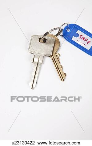 Stock Image - Keys with key ring tag on white background. Fotosearch