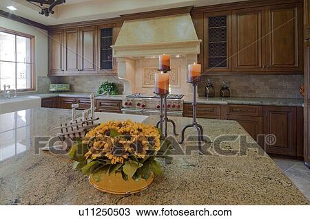 Stock Image - Kitchen bench with flowers. Fotosearch