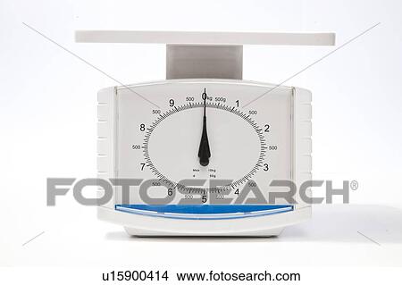 Picture - Kitchen weighing scale over white background. Fotosearch