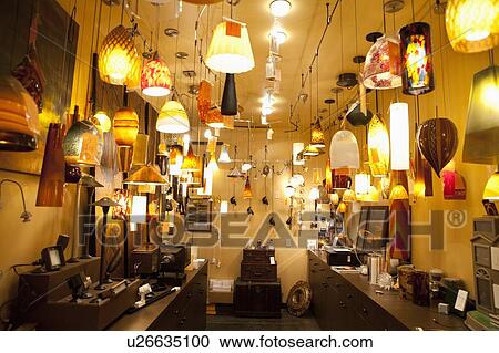 Stock Image - Large group of lighting fixtures on display in store. Fotosearch