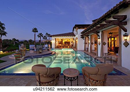 Stock Image - Lighting effect in swimming pool of mansion. Fotosearch