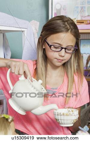 Little girl playing with tea set View Large Photo Image Stock Photo - Little girl playing with tea set. Fotosearch
