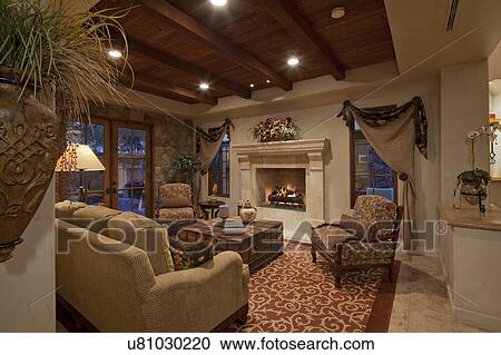 Stock Image - Living room interior with fireplace in luxury villa. Fotosearch
