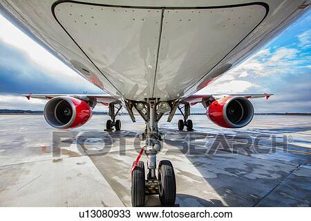 Stock Image - Low angle view of airplane in airport. Fotosearch