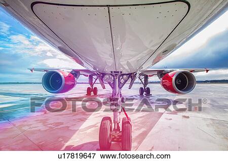 Stock Photo - Low angle view of airplane in airport. Fotosearch