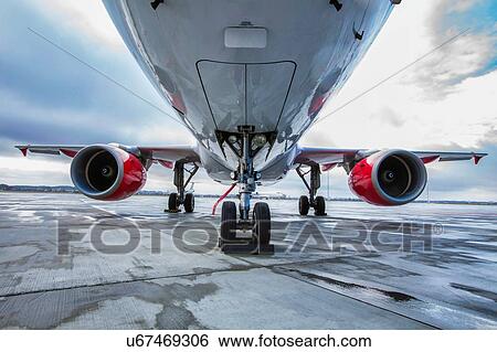 Stock Photograph - Low angle view of airplane in airport. Fotosearch
