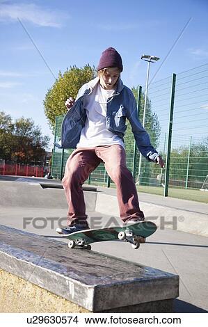 Low angle view of young man skateboarding View Large Photo Image Picture - Low angle view of young man skateboarding. Fotosearch