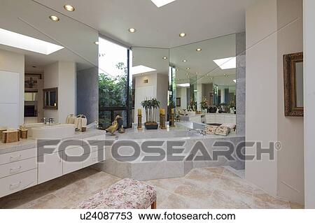 Stock Image - Luxurious bathroom with bathtub in mansion. Fotosearch