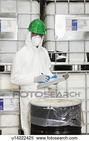 Male technician in hazmat suit taking down notes of chemical in drum View Large Photo Image Stock Photography - Male technician in hazmat suit taking down notes of chemical in drum. Fotosearch
