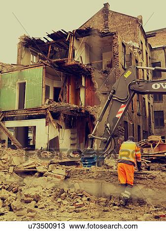 Stock Image - Man at demolition site. Fotosearch