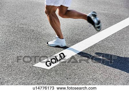 Stock Image - Man running on white line with gold winner sign. Fotosearch