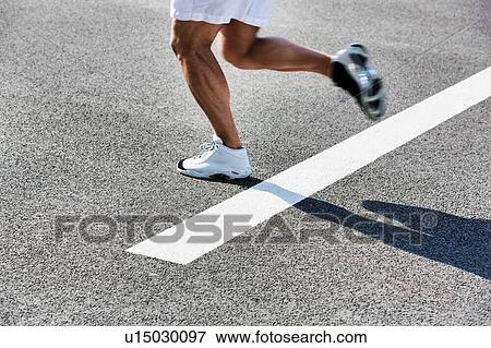Stock Photo - Man running on white starting line. Fotosearch