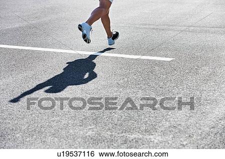 Stock Photograph - Man running on white starting line. Fotosearch