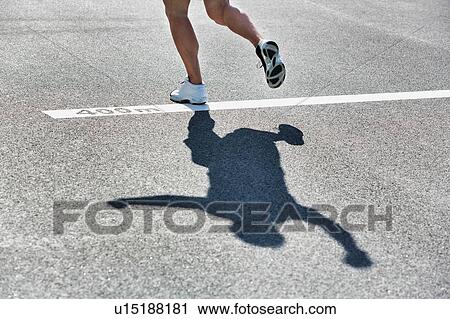 Stock Image - Man standing on 400 meter dash. Fotosearch