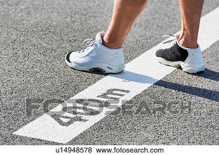 Man standing on 400 meter dash View Large Photo Image Stock Photo - Man standing on 400 meter dash. Fotosearch