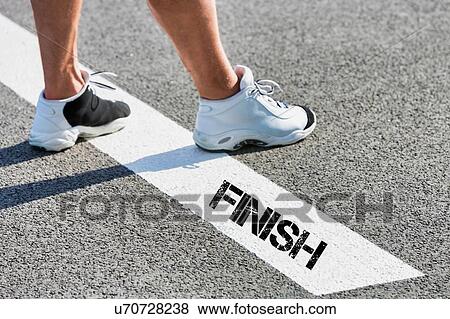 Man standing on finish line View Large Photo Image Stock Photo - Man standing on finish line. Fotosearch
