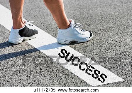Man standing on stepping on white line with success sign View Large Photo Image Stock Photography - Man standing on stepping on white line with success sign. Fotosearch