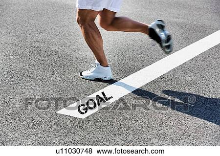 Stock Photo - Man stepping on white line with goal sign. Fotosearch