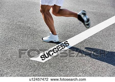 Stock Image - Man stepping on white line with success sign. Fotosearch