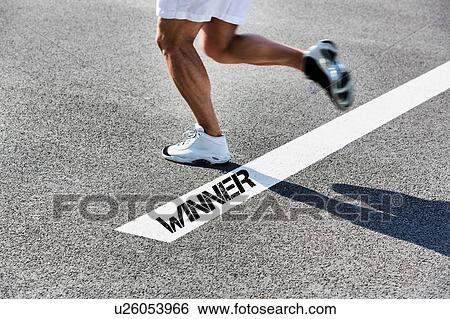 Stock Photograph - Man stepping on white line with winner sign. Fotosearch