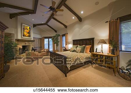 Stock Photography - Master bedroom interior with fireplace in manor house. Fotosearch