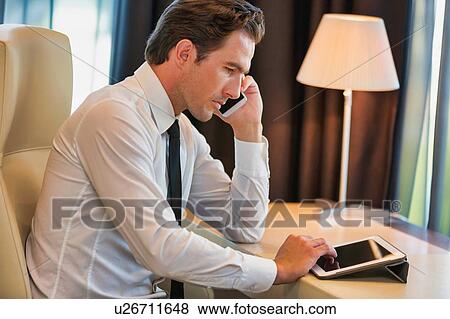 Stock Photo - Mature businessman talking on smartphone. Fotosearch