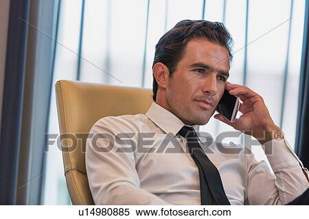 Mature businessman talking on smartphone View Large Photo Image Stock Photography - Mature businessman talking on smartphone. Fotosearch