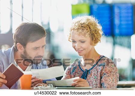 Mature couple looking at their boarding pass in airport View Large Photo Image Stock Image - Mature couple looking at their boarding pass in airport. Fotosearch