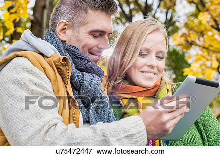 Mature couple walking in park in Autumn View Large Photo Image Stock Photo - Mature couple walking in park in Autumn. Fotosearch