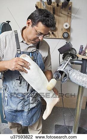 Mature male worker buffing prosthetic limb View Large Photo Image Stock Image - Mature male worker buffing prosthetic limb. Fotosearch