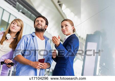 Mature man traveling with her sister while asking for assistance with the airport staff View Large Photo Image Stock Photograph - Mature man traveling with her sister while asking for assistance with the airport staff . Fotosearch