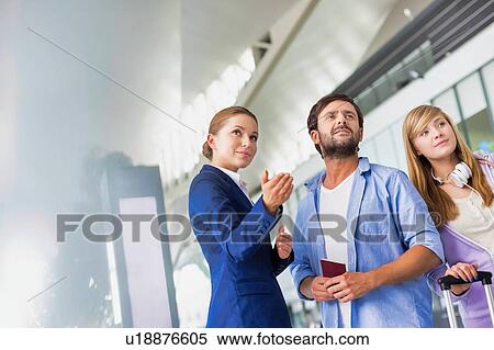 Mature man traveling with her sister while asking for assistance with the airport staff View Large Photo Image Stock Photography - Mature man traveling with her sister while asking for assistance with the airport staff . Fotosearch