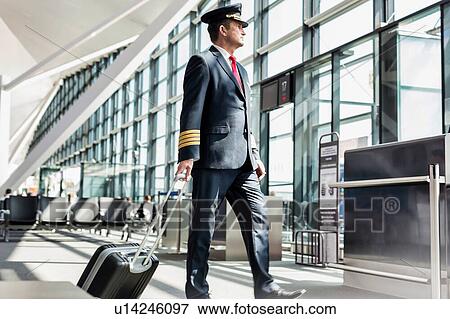Mature pilot walking to enter the plane in boarding gate at airport View Large Photo Image Stock Photo - Mature pilot walking to enter the plane in boarding gate at airport. Fotosearch