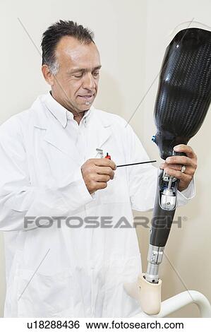 Mature technician working on prosthetic foot View Large Photo Image Stock Photograph - Mature technician working on prosthetic foot. Fotosearch