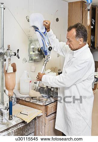 Mature technician working on prosthetic foot View Large Photo Image Stock Photography - Mature technician working on prosthetic foot. Fotosearch